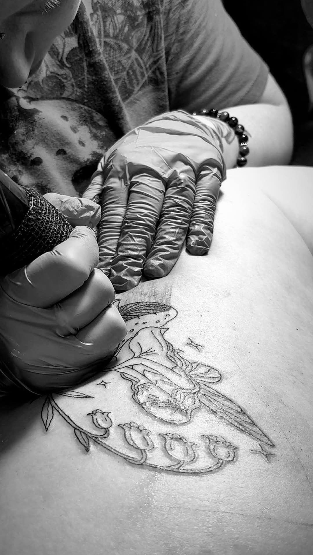 Paige tattooing in the chair