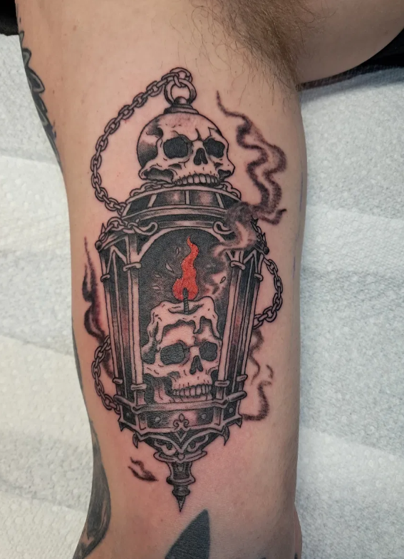 Skull lantern tattoo with candle and smoke