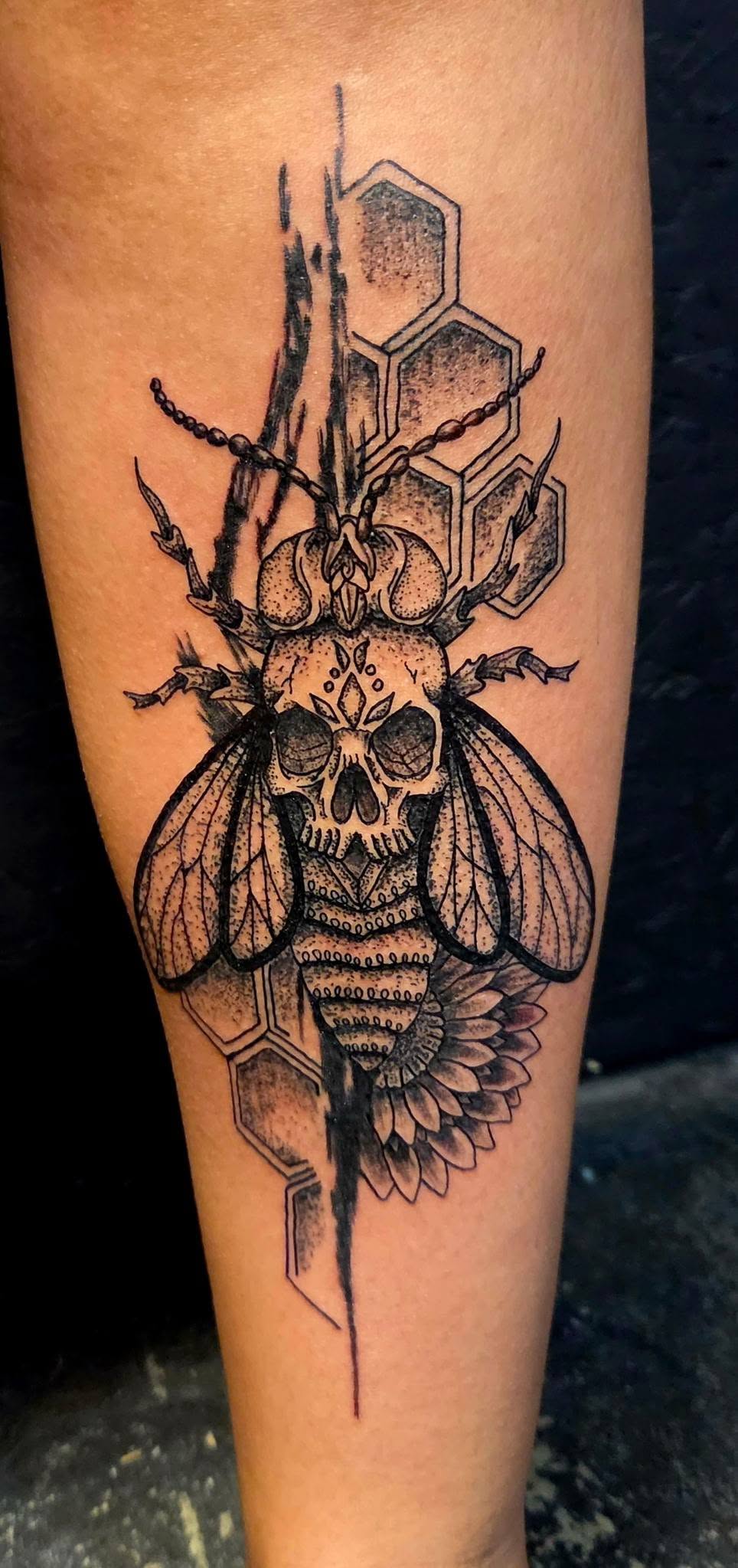 Skull bee tattoo with honeycomb and floral accents